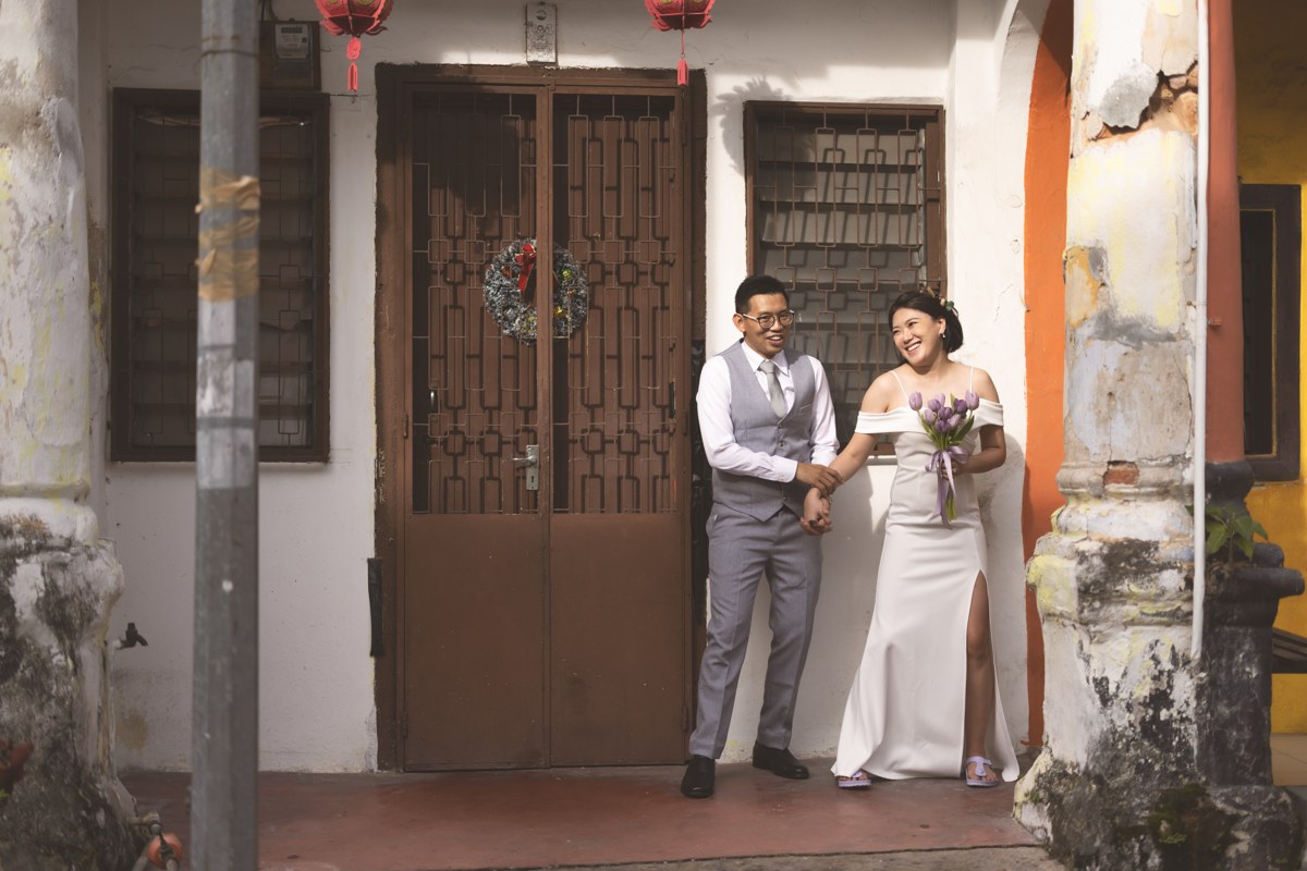 Wedding couple standing together in a historic doorway
